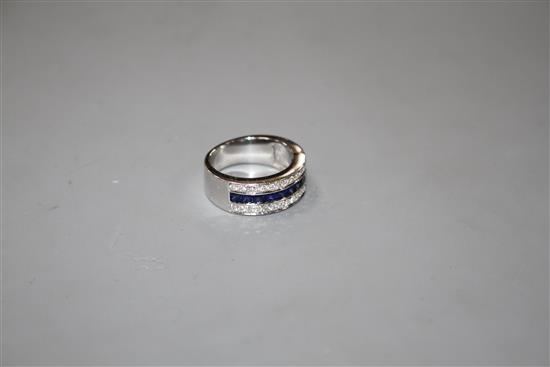 A modern 750 white metal sapphire and diamond set three row half eternity ring, size M, gross 9.2 grams.